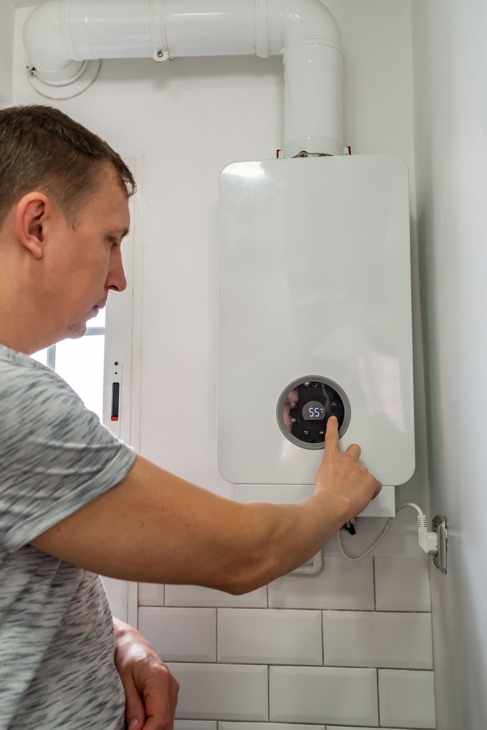 a man changing the temperature of his water heater