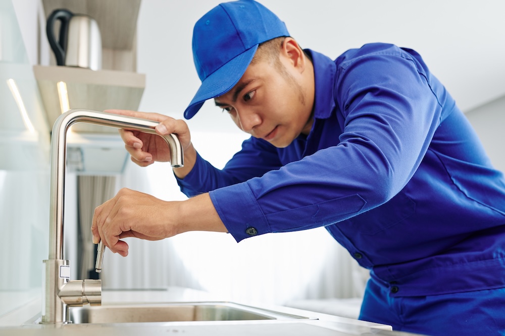 a plumber fixing a sink